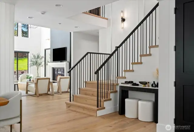 Metal and wood railing accent the wood steps to upstairs area