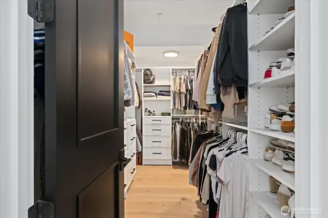 Master closet features shelves and hangar space for all your occassions