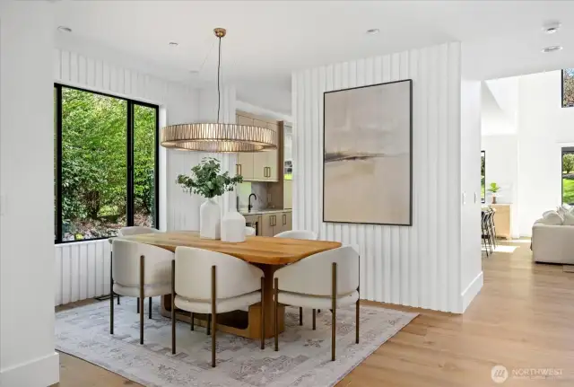 Formal dining area w/views to restful grounds and peeks into the great room