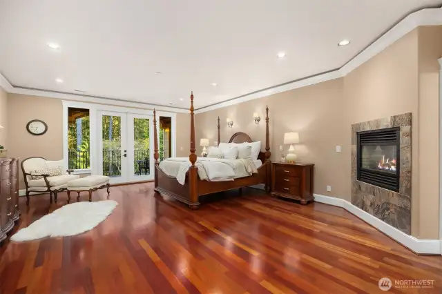 Primary bedroom with french doors to balcony overlooking grounds.