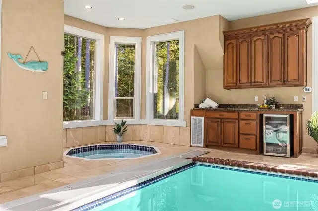 tons of natural light, hot tub, wet bar, pool shower and 1/2 bath behind photographer