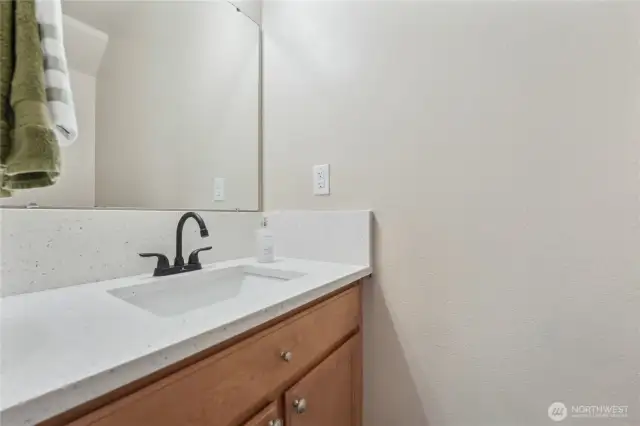 Guest bath on main with quartz countertop.