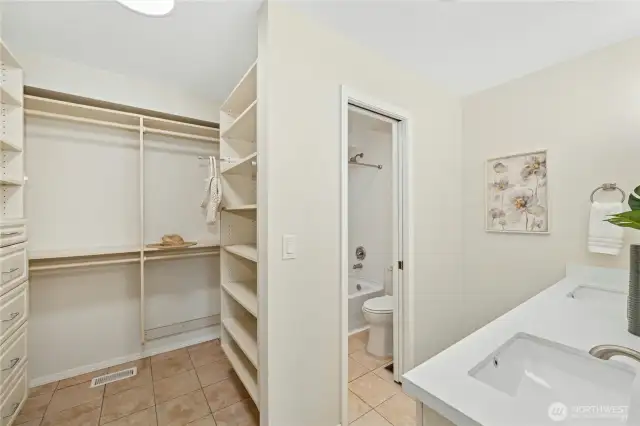 Roomy walk-in closet and Primary bath with lots of new features: quartz countertop, double sinks, mirrors, faucets, lighting and a new tub too.