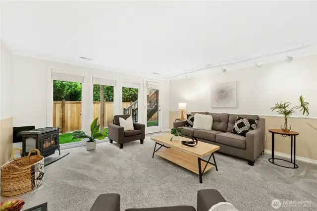 Welcome to this sensational family room with access to the back patio and yard. The gas free-standing fireplace offers tons of cozy warmth during the cooler months.