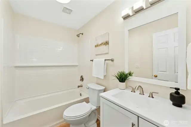 A very cheery, completely updated full bath on the daylight level...
