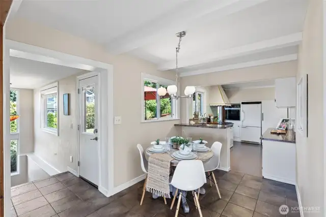 Looking into the Kitchen and Dining. area. One door out at top of the stair leads to the back deck area and creates a nice separate entry for guests or home office or business.