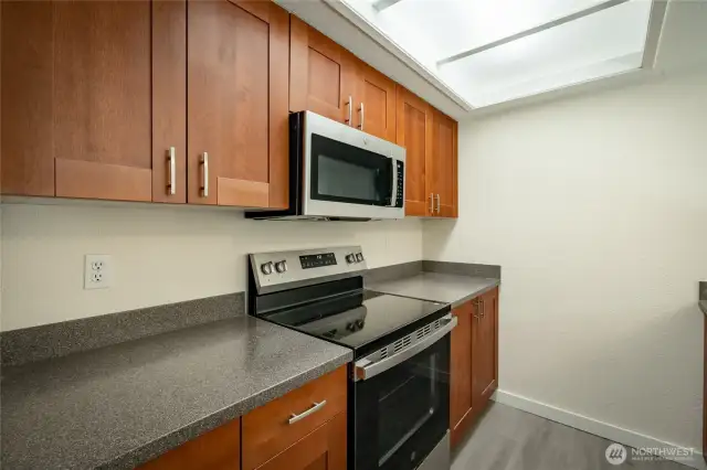 Galley kitchen opens to dining room.