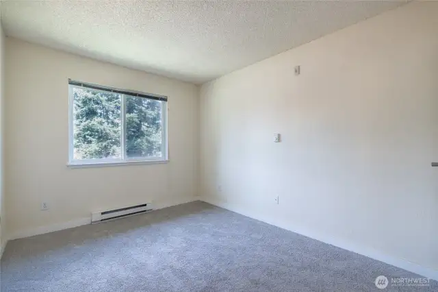 Main bedroom faces north and opens onto en suite bathroom and two closets.