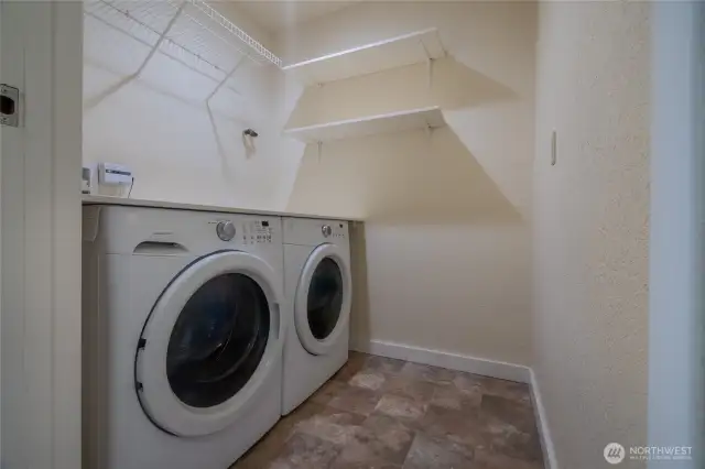 Separate laundry room with full washer and dryer.