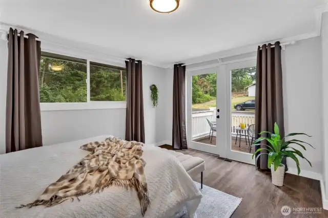 Primary bedroom with French doors to private balcony.