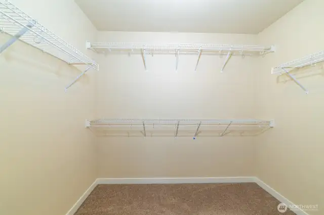Spacious walk-in closet connected to the main primary ensuite bath