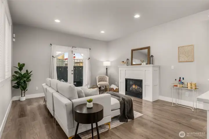 Living room has french doors leading out to the backyard patio