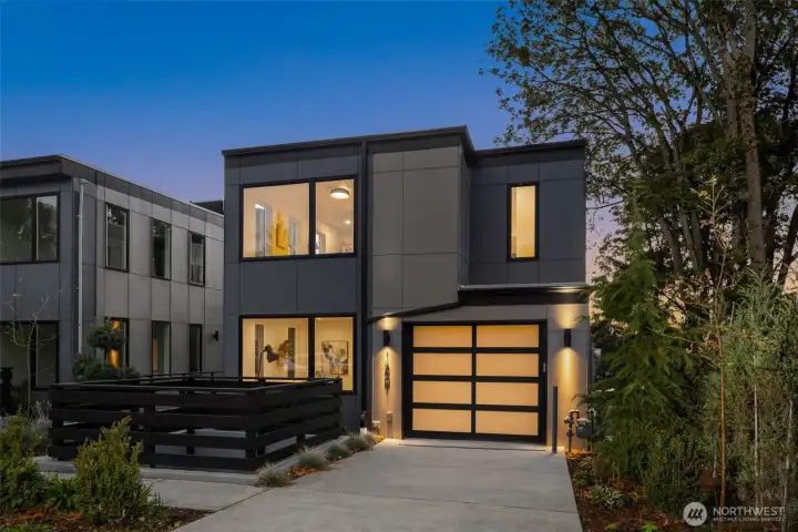 Sophisticated curb appeal meets modern craftsmanship. The interplay of wood, glass, and metal details creates a striking yet inviting exterior that hints at the elegance waiting inside.