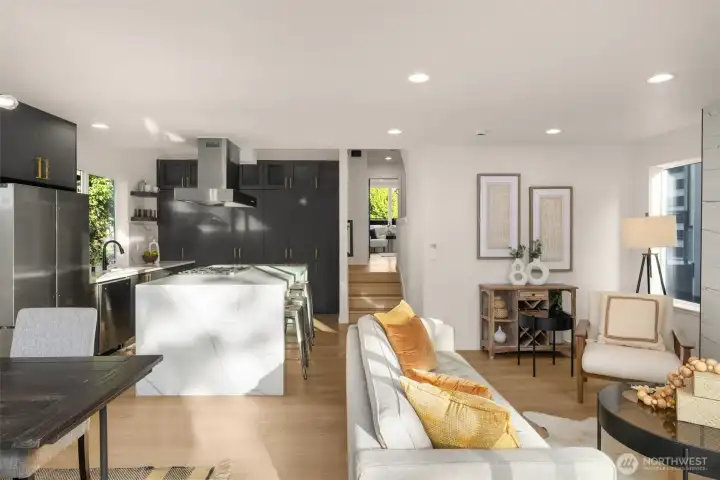 Step through the door into an airy, open-concept living space that feels both expansive and intimate.