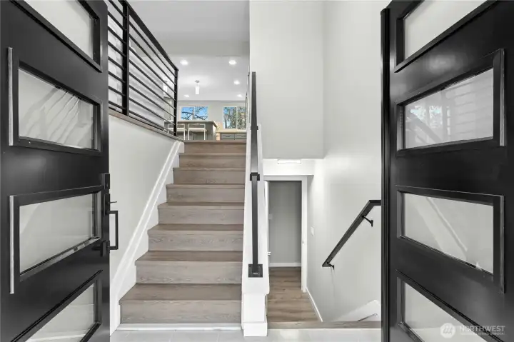 Light filled entry showcasing New Luxury Vinyl Plank flooring.