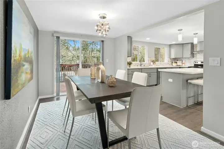 Spacious dining room right off the kitchen and opens up to expansive deck.