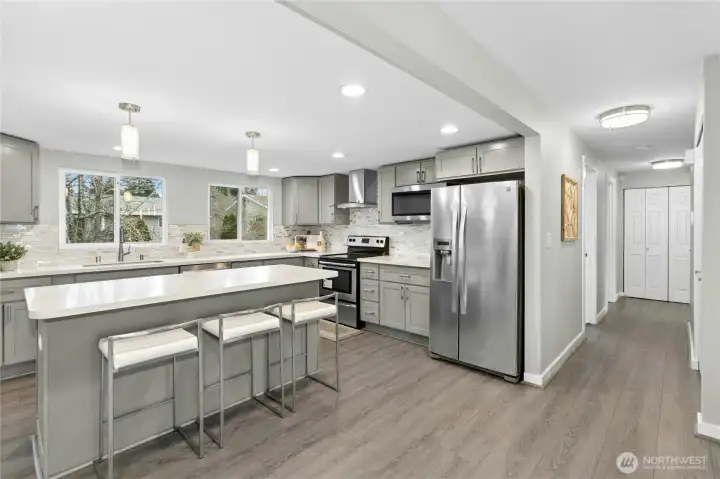Modern kitchen with quartz counters and stainless steel appliances.