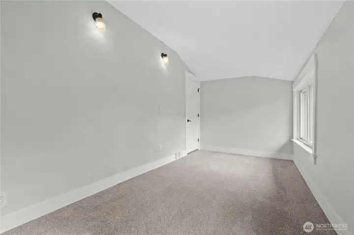 Bedroom #2 w/view of the opposite wall with sconces for unique lighting feature.