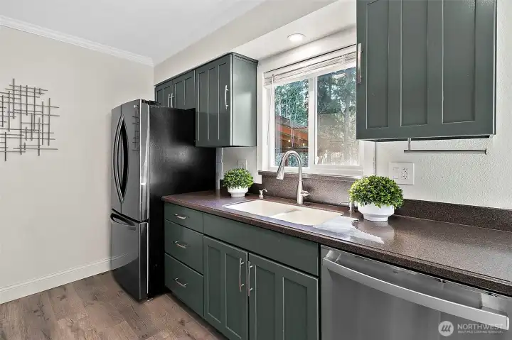 Kitchen sink window open to deck area and over looks the backyard.