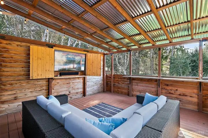 Covered deck with bar top area and TV for outdoor gatherings!