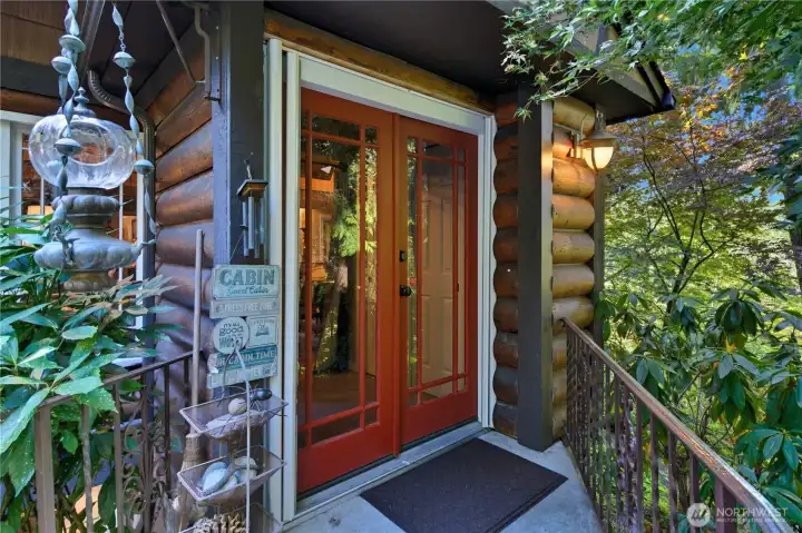 Inviting front entry with classic log siding and warm, rustic character.
