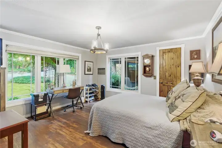 Primary bedroom on main level with ensuite bath.  Tranquil views are enjoyed from the multiple windows.