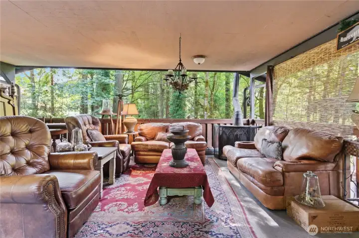 Step outside to a stunning covered outdoor living space designed for year-round enjoyment and is perfect for the Pacific Northwest lifestyle.  This sheltered outdoor living area blends comfort with nature.