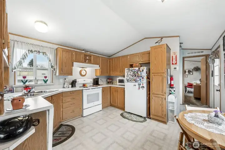 Vaulted ceilings & open kitchen with plenty of cabinet space.