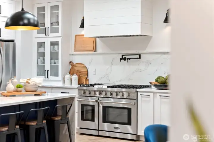 Professional range and gorgeous custom hood with pot filler!