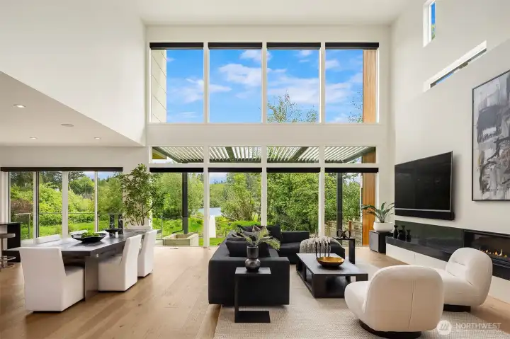 Open spaces with 22' ceilings offering a wall of windows facing east overlooking the lake and private grounds