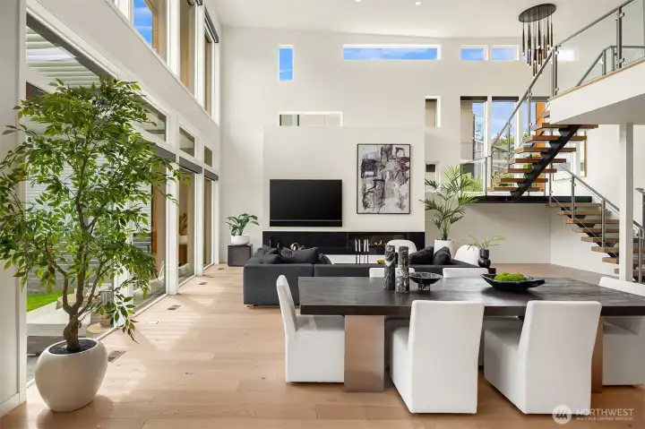 Open Living and Dining room open with a floating staircase leading to the upper level
