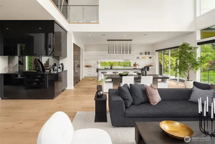 The living and dining rooms open to a chef's kitchen with large center island offering additional seating