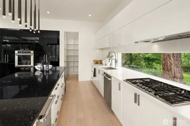 Four burner cook-top and double oven. Large walk-in pantry