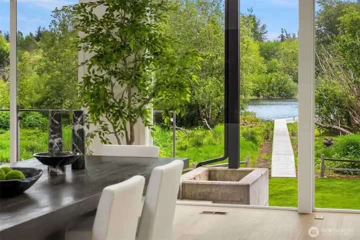 The dining room overlooks the lake, and has a for to the covered patio with pergola, for easy indoor/outdoor transition