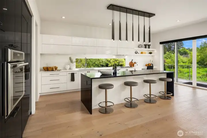 A new chandelier lights up the sleek kitchen island