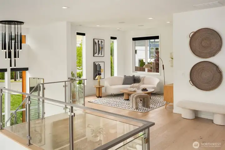 An open bonus space at the top of the stairs offers a place for relaxing or work from open office space