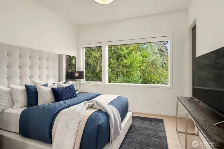 Main level bedroom suite with en-suite three-quarter bathroom.