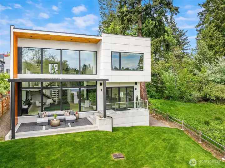 The rear of the home with raised patio. Lower Patio has new StruXure outdoor electric pergola.