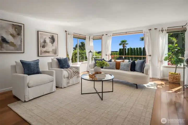 The main living room is enormous with a versatile floorplan that opens up to the front deck through the french doors.