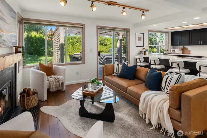 This family room is a welcome second lounge area with a wood burning fireplace and easy access to the amazing back deck and yard.
