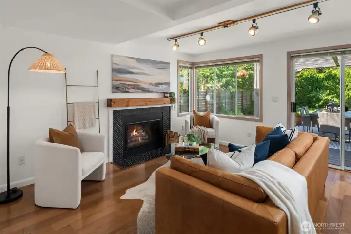 The family room is anchored by the wood burning fireplace and designer tiled surround.
