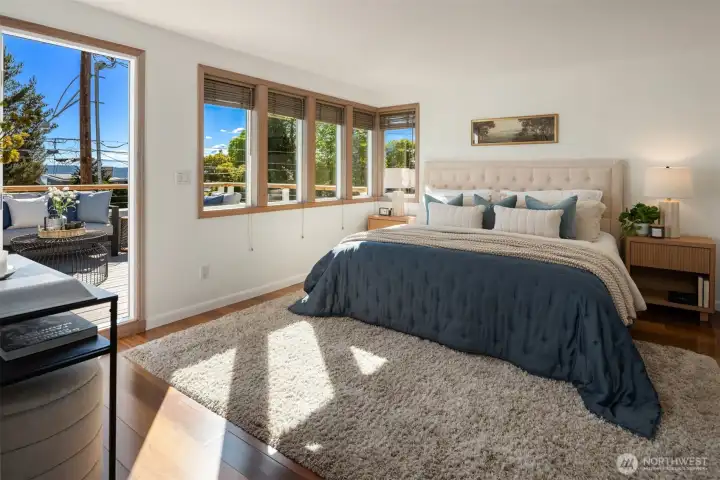 On the second floor you'll find three bedrooms including this king sized primary with a huge view deck not to mention an enormous walk-in closet and en suite.