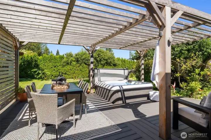 Just off the family room is this stunning deck with hot tub and arbor.