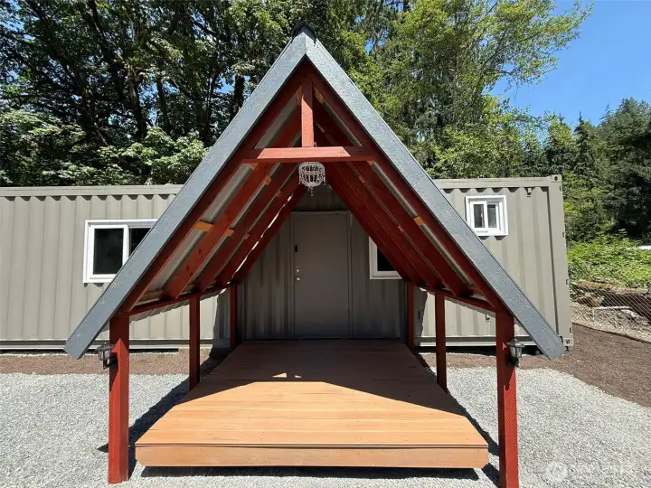 Front door of cabin with porch