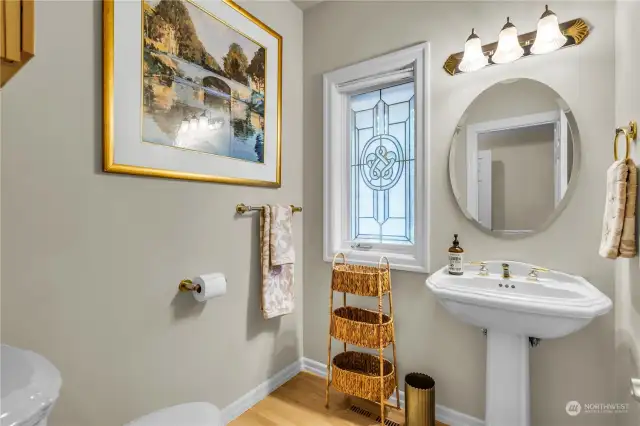 This is the hall powder room.  Check out the Matterport walking tour posted in the listing to get a full experience at the layout.  notice the beveled glass window?  It's part of the foyer design.