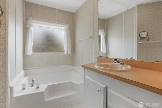 Master bedroom suite with a walk in closet and a 5 piece bathroom.