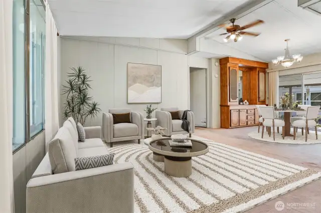 Formal living room with vaulted ceilings overlooks community greenbelt, opens to dining room.  Virtually staqed photo.