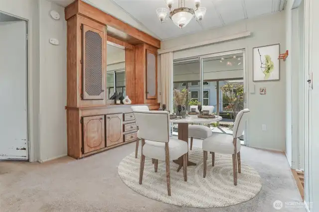 Formal dining room with built in hutch, opens to living room.  Virtually staged photo.