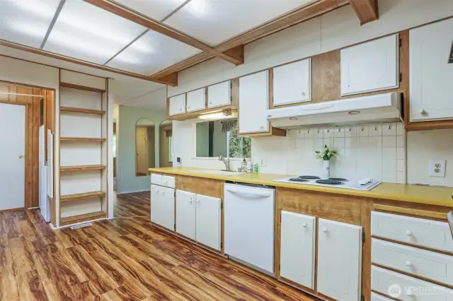Spacious kitchen with an eating area and laminate floors.