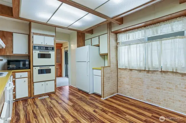 Spacious kitchen with an eating area and laminate floors.